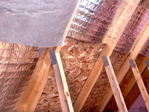 Roof insulation installed between wooden rafters